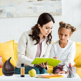 Mother Teaching Daughter While Diffusing Egyptian Musk Fragrance Oil